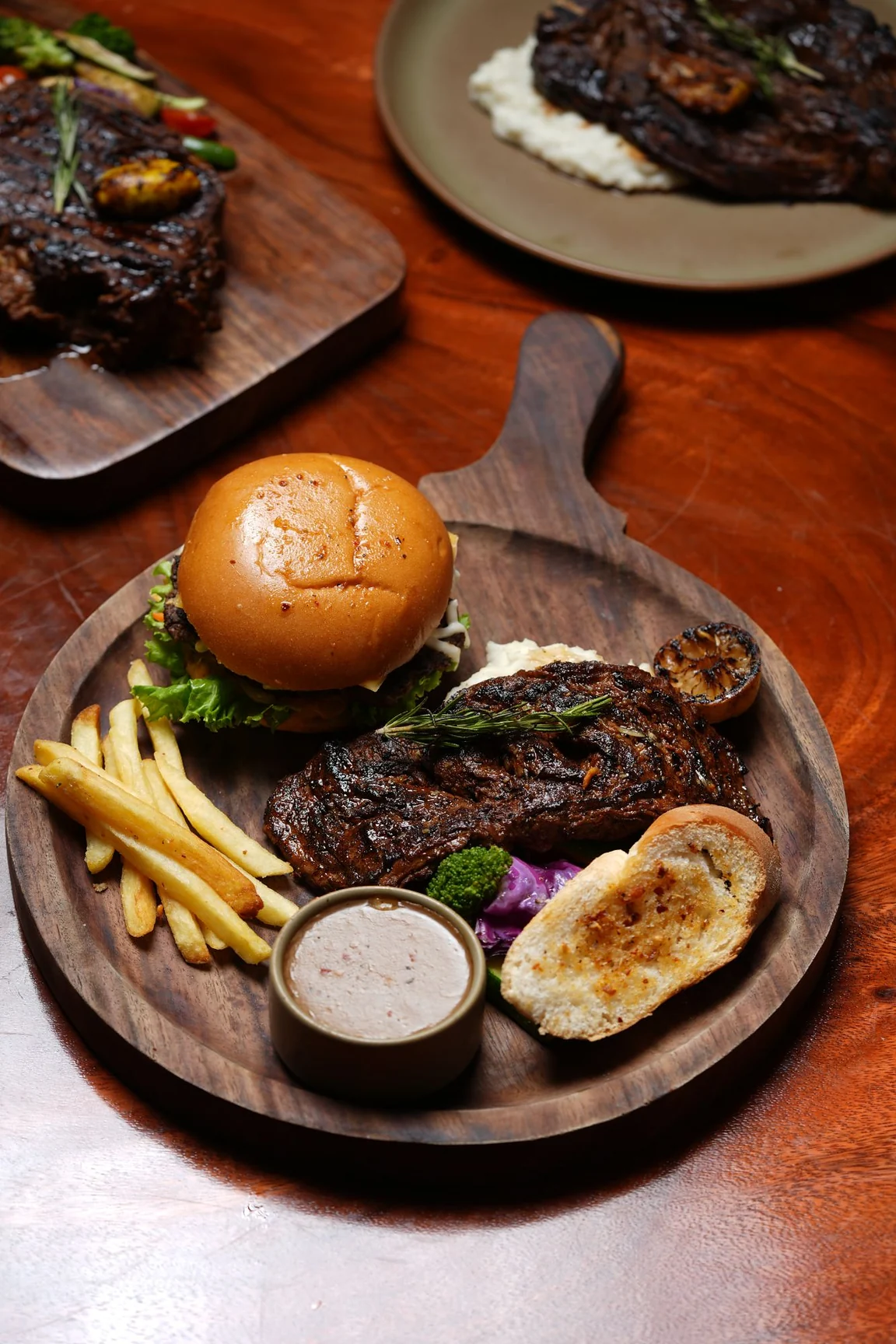 A steak and burger platter for a group meal