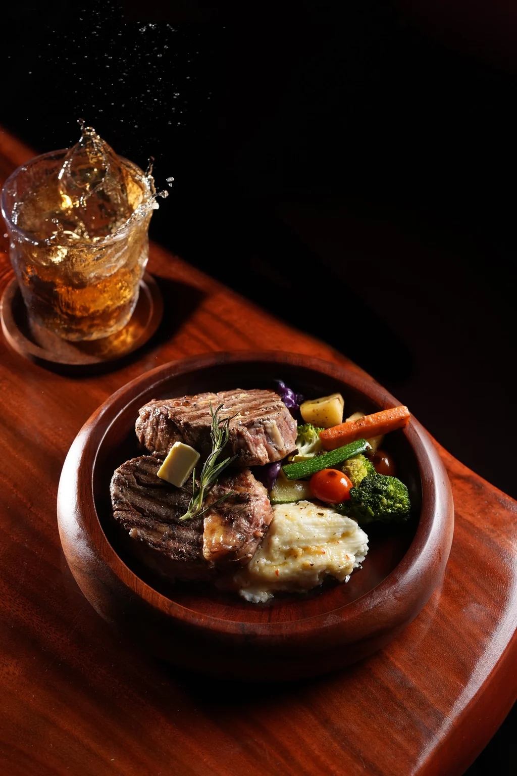 Pan Grilled Wagyu plated with charred vegetables and a whisky pour